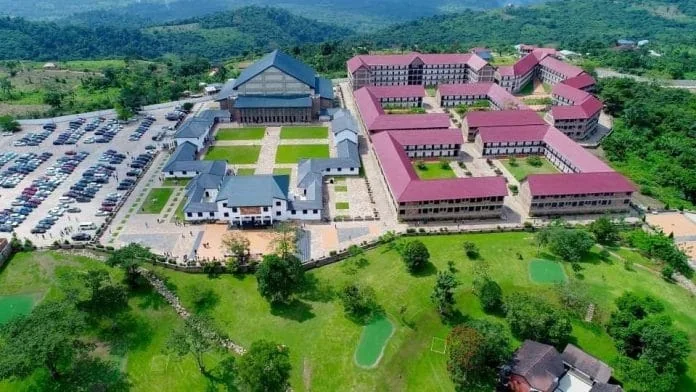 Aerial view of the Anagkazo campus in green hills, with red-roofed halls and lawns.